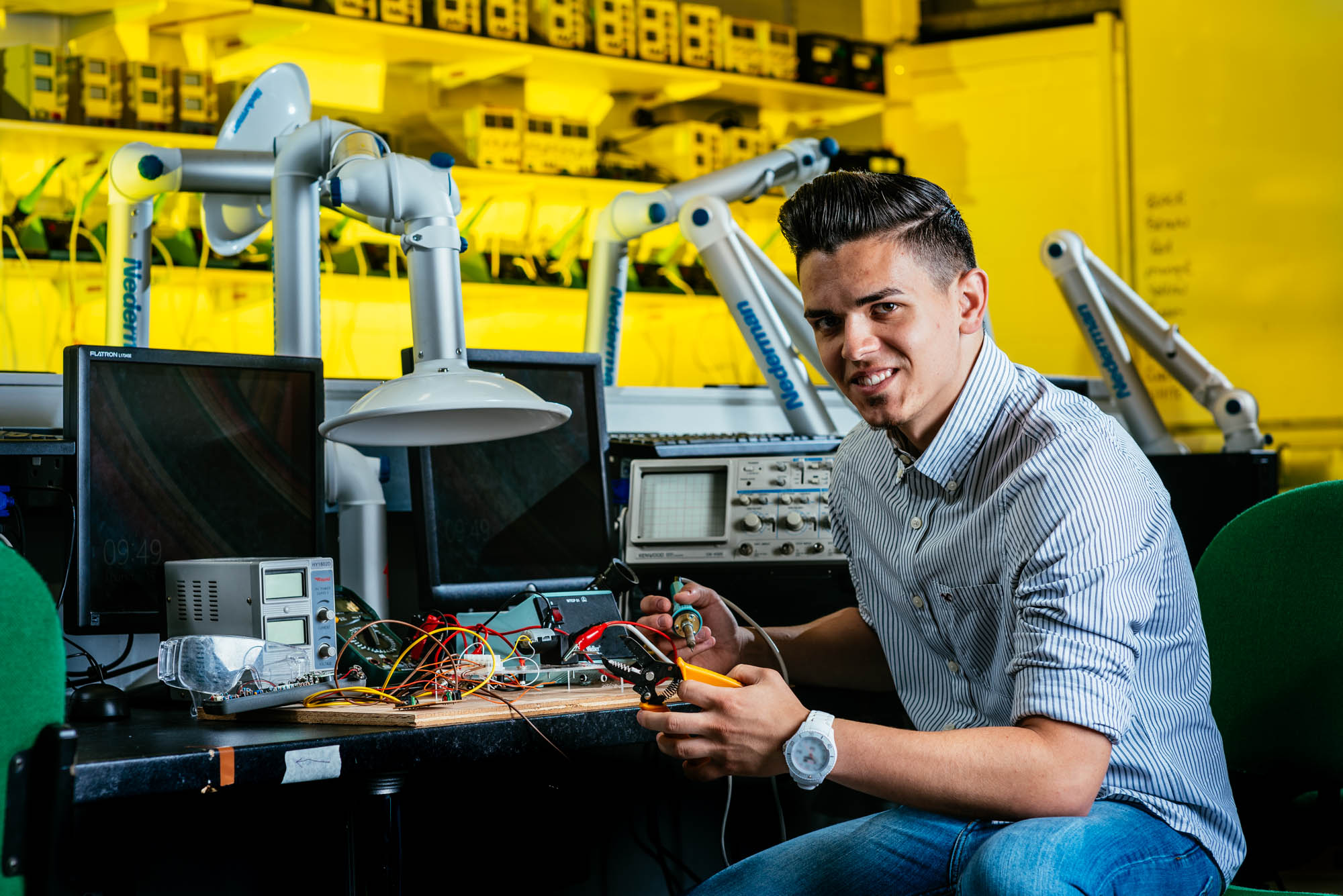 A photo of an engineering student working in a lab at a college