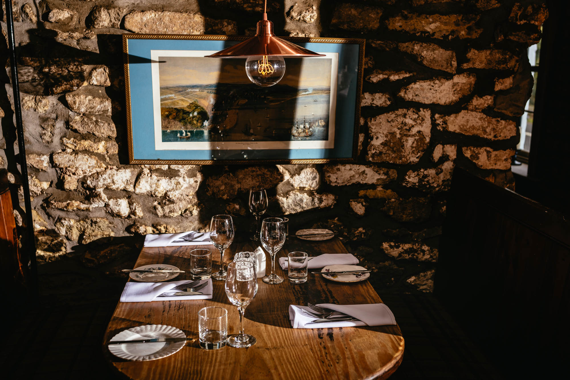 A photo of evening sunlight casting shadows on the interior of a pub